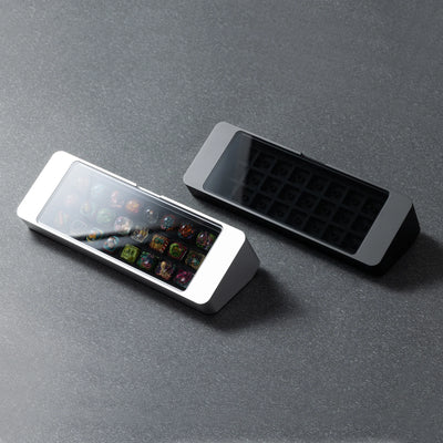 Bliss Artisan Tray shown in Black and Silver finishes — 24-slot keycap display case with tempered glass lid